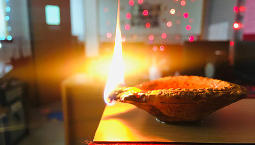 Close-up of lit candles on table