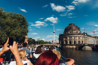 Tourists on pier at river