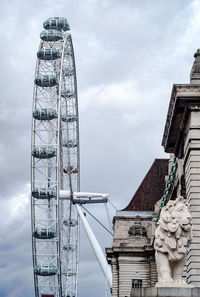 Low angle view of ferris wheel against building