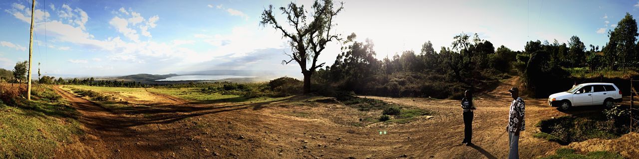 sky, landscape, tranquility, tree, tranquil scene, transportation, nature, scenics, road, cloud, mountain, non-urban scene, field, cloud - sky, beauty in nature, sunlight, plant, remote, no people, dirt road