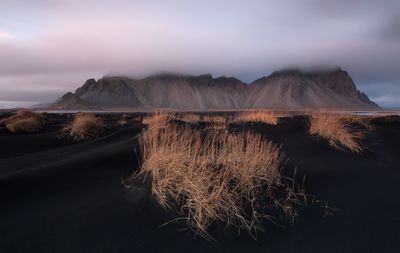 Scenic view of mountains against cloudy sky