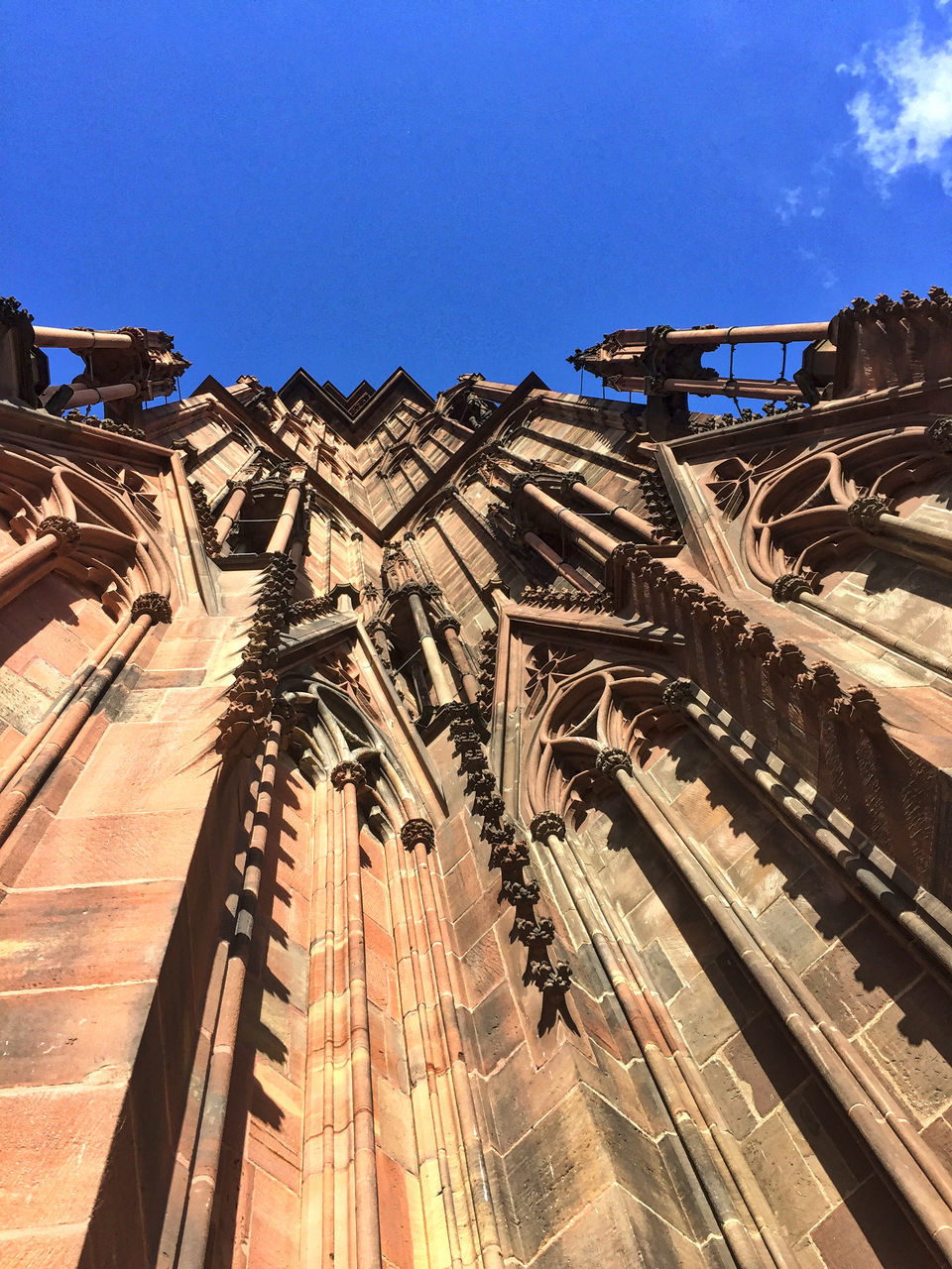 architecture, built structure, clear sky, building exterior, low angle view, blue, travel destinations, tourism, development, famous place, city life, outdoors, day, history, sky, stone material, international landmark, wide shot, wide, old town, skyscraper, the past, vacations, tall - high, no people