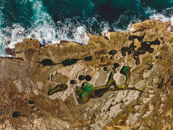 High angle view of rocks by sea