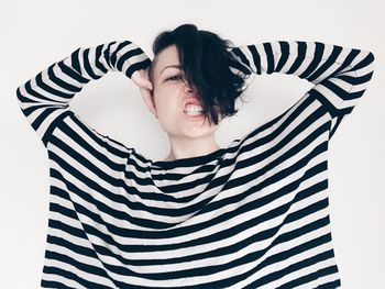 Portrait of young woman against blue sky