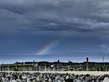 Rainbow over mountains against sky