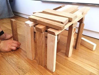 Low angle view of human hand on hardwood floor