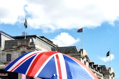 Low angle view of flag against buildings in city