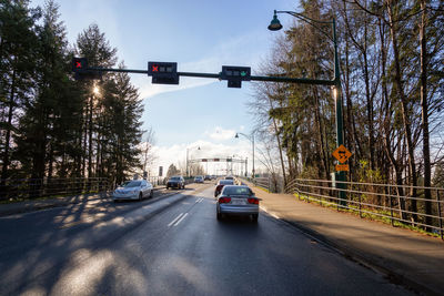 Cars on road against sky