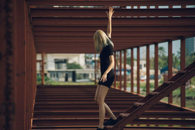 Side view of woman moving down wooden steps