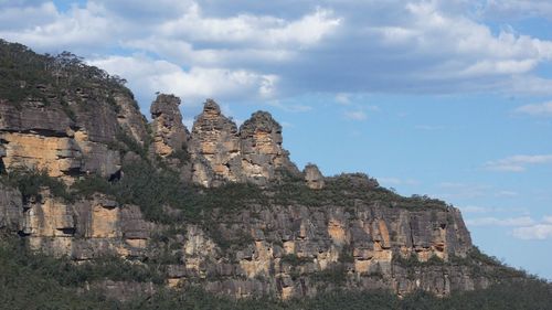 Low angle view of rock formations against sky