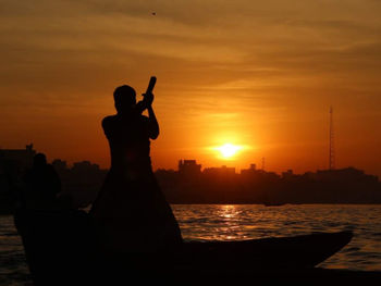 Silhouette statue against sky during sunrise 