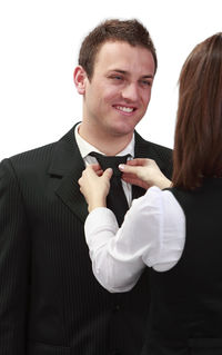 Smiling young couple against white background