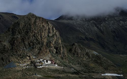 Houses against rocky mountains