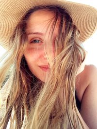 Portrait of beautiful young woman wearing hat