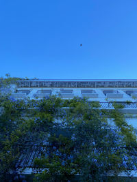 High angle view of buildings against clear blue sky
