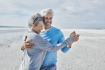 Happy couple dancing on the beach