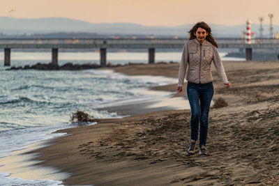 Full length of woman standing on beach