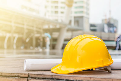 Close-up of yellow hat on table at construction site