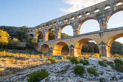 The magnificent pont du gard at setting sun. ancient roman aqueduct bridge.  photography in france.