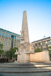 Low angle view of statue against sky in city