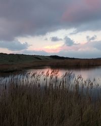 Scenic view of lake against sky during sunset