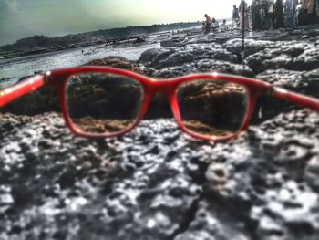 Close-up of sunglasses against water