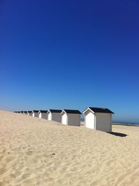 Scenic view of beach against clear blue sky