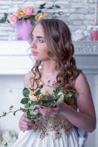Close-up of beautiful young woman with bouquet