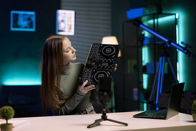 Midsection of woman using mobile phone in office