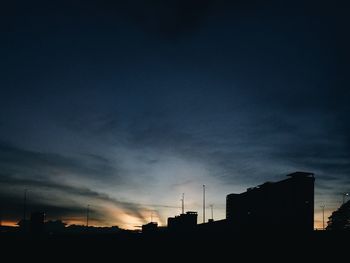 Low angle view of silhouette buildings against sky