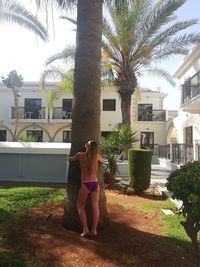 Rear view of woman standing in front of building