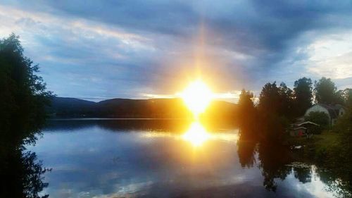 Scenic view of lake against cloudy sky