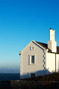 Low angle view of old building against clear blue sky