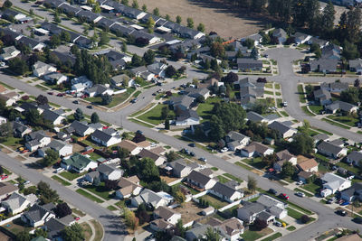 High angle view of houses amidst buildings in city