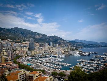 High angle view of townscape by sea against sky