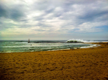 Scenic view of sea against cloudy sky