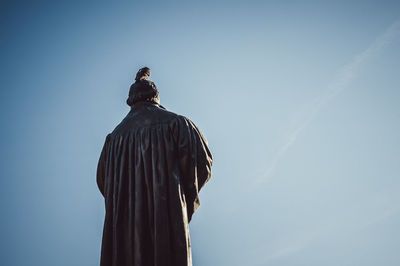 Low angle view of statue against clear blue sky