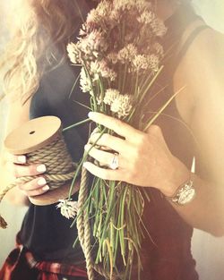 Close-up of hand holding flowers