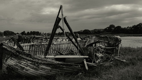 Abandoned ship on shore against sky