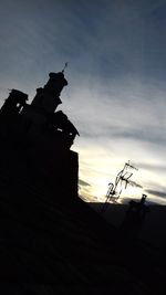 Low angle view of silhouette statue against sky during sunset