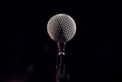 Close-up of lighting equipment against black background