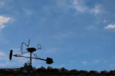 Low angle view of street light against blue sky