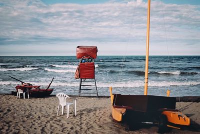 Lifeguard hut on beach against sky