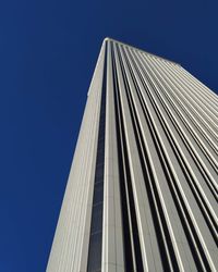 Low angle view of modern building against clear blue sky