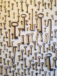 Full frame shot of various keys hanging on wall
