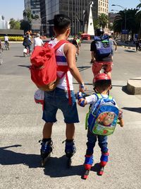 Rear view of people on street in city