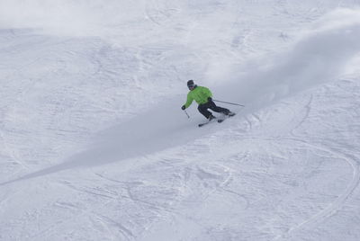 High angle view of man skiing on snow covered land