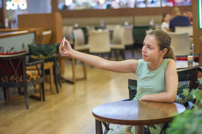 Girl sitting on table