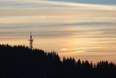 Silhouette trees against sky during sunset