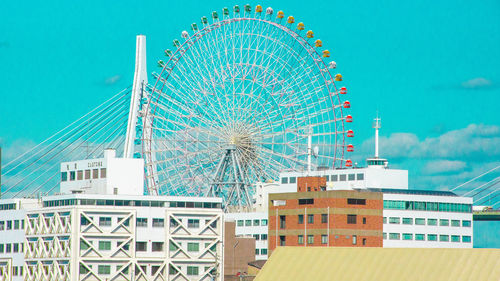 Low angle view of ferris wheel against building